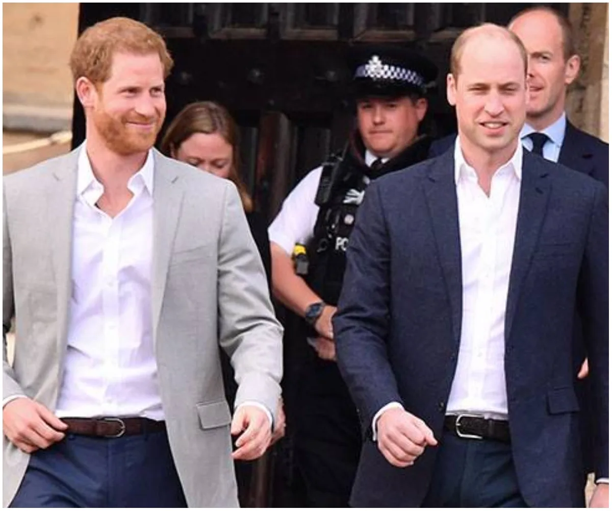 Prince Harry and Prince William walking together, smiling, in suits.