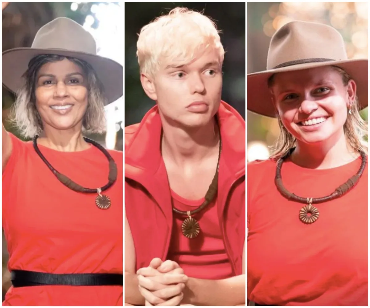 Three contestants from "I'm a Celebrity Australia 2021" in red outfits and hats, smiling at the camera.