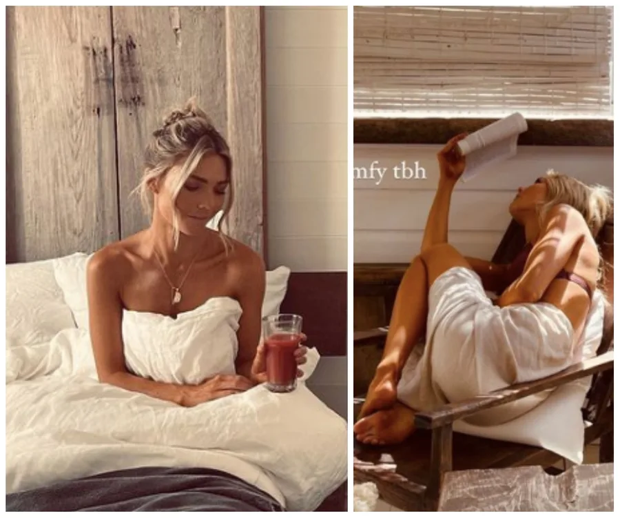 A woman sits on a bed holding a drink and relaxes in a chair reading, both wrapped in white sheets.