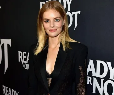 Samara Weaving at the "Ready or Not" premiere, wearing a black lace-detailed suit.
