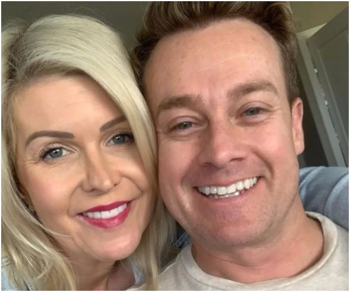 A couple smiling closely together for a selfie, both with light hair.