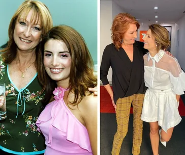 Two women in casual and elegant outfits, posing together and smiling warmly at one another.