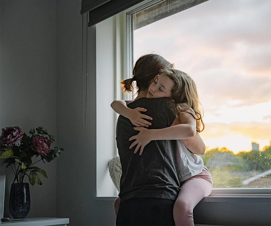Mother and daughter in embrace.