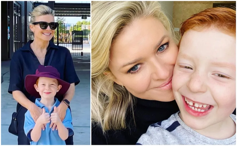 A woman smiles with her young son in a school uniform and sun hat, both appearing happy outside a school.