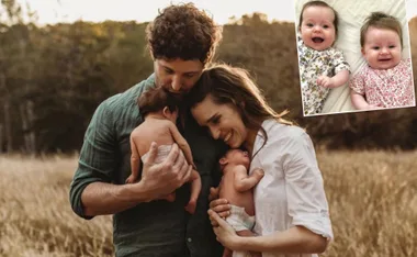 A couple embraces their twin babies in a field; inset shows twins smiling in floral outfits.
