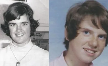Two young individuals smiling, one in black and white and the other in color, with short hair.