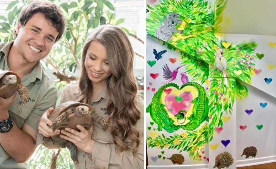 Couple holding tortoises in zoo uniforms; colorful wildlife-themed nursery mural with animals and hearts.