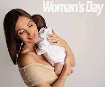 Woman holding a baby lovingly with "Woman's Day" text in the background.