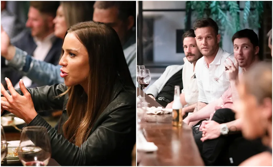 Group dinner scene with intense conversation; people are seated with drinks on the table.