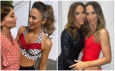 Two women in stylish outfits, one wearing a polka-dotted top, the other in a black sequin dress, smiling together.