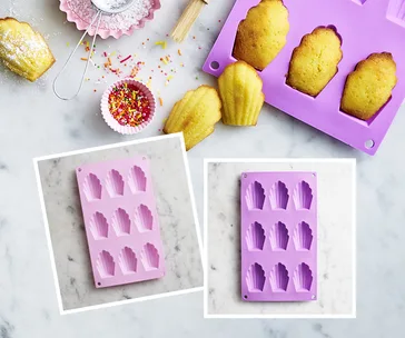 Silicone madeleine baking pan with baked madeleines and sprinkles on a marble surface.
