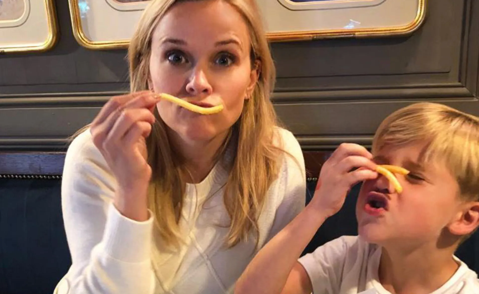 Reece Witerspoon eating fries with son