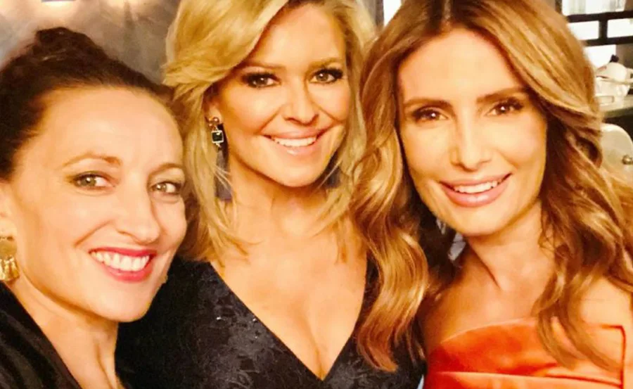 Three smiling women from the Home and Away cast posing for a photo together.