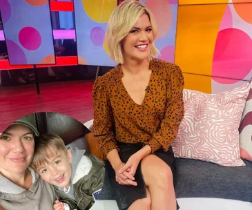 Blonde woman in brown patterned blouse on a colorful TV set, inset of her with a child in casual attire.