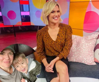 Blonde woman in brown patterned blouse on a colorful TV set, inset of her with a child in casual attire.