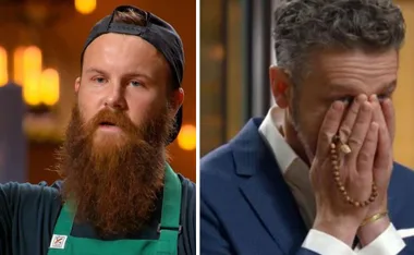 "Bearded man in apron, somber, beside older man in suit, hands covering face in emotion."