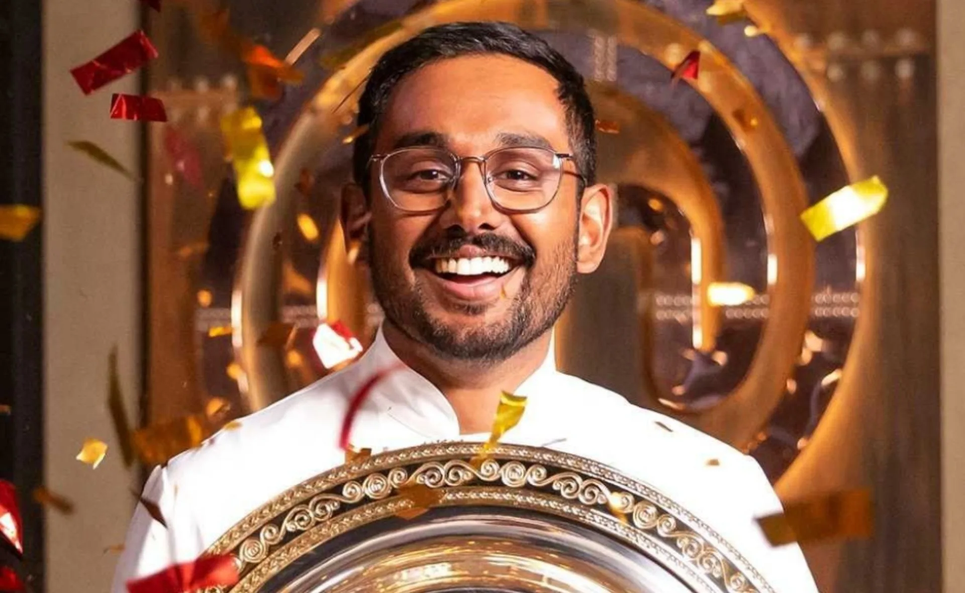 Winner of MasterChef 2021 joyfully holding a trophy, surrounded by colorful confetti.