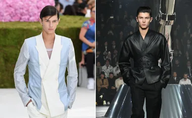 Model walking in a light blazer with striped sleeves; another in a dark, sleek outfit on a runway.