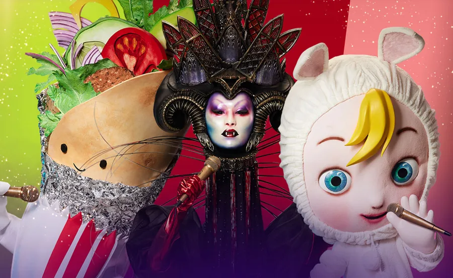Three colorful masked characters from "The Masked Singer" 2021, wearing elaborate costumes and holding microphones.