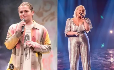 Two singers performing on stage; one wears a colorful jacket, the other a shiny silver outfit, both holding microphones.