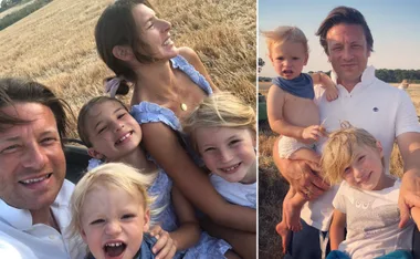 Happy family in a sunny field, smiling and enjoying time together.