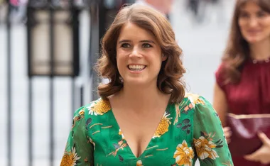 I don't know who they are, but they are smiling in a floral outfit outdoors.