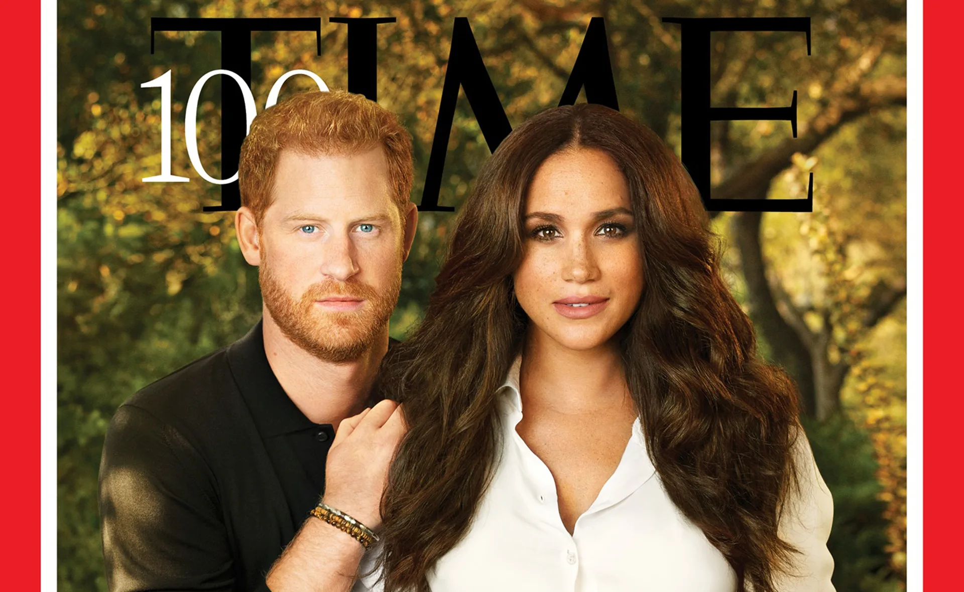 "Prince Harry and Meghan Markle on Time cover, posed outdoors with trees in background."