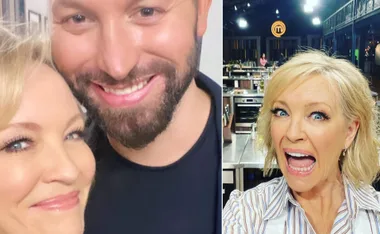 Celebrity MasterChef contestant smiles with another man in a selfie; she is excited, with a kitchen in the background.
