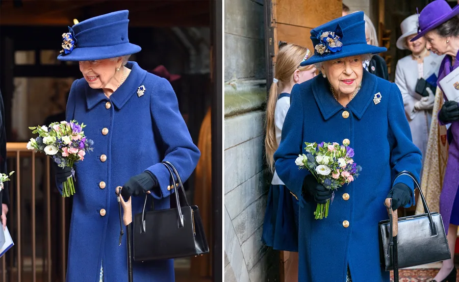 Elderly woman in blue coat and hat, holding a bouquet and walking stick, surrounded by people.