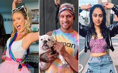 Three people; one with rainbow accessories, one holding a dog in tie-dye, and one with sunglasses on head in leopard top.