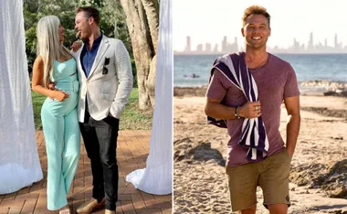 Man in beach attire with towel, another man in jacket with a woman in matching outfit, outdoor setting.