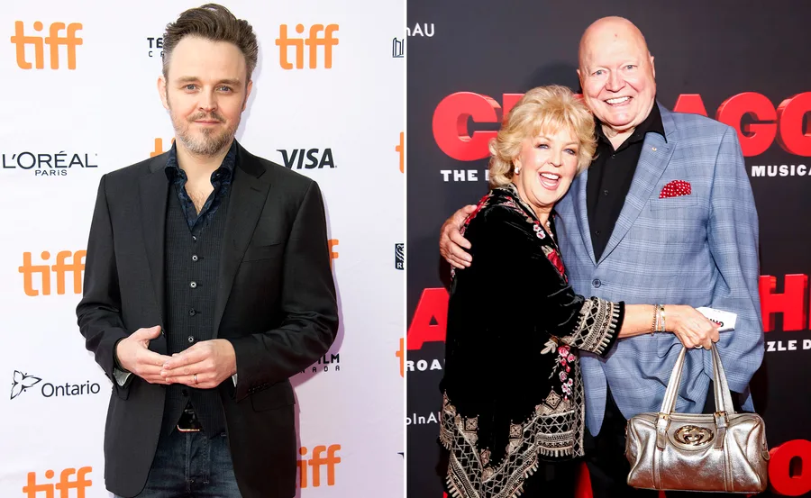 Man in a suit at TIFF event next to a smiling couple embracing at a red carpet event.