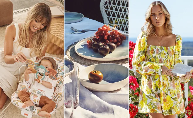 A woman playing with a baby, a fruit-laden table, and another woman holding a book in a floral dress.
