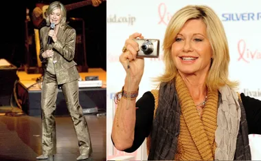 Olivia Newton-John performing on stage and smiling with a camera in Japan.