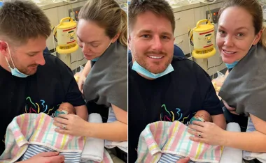 Couple holding newborn twins wrapped in colorful blankets, both parents smiling in hospital setting.