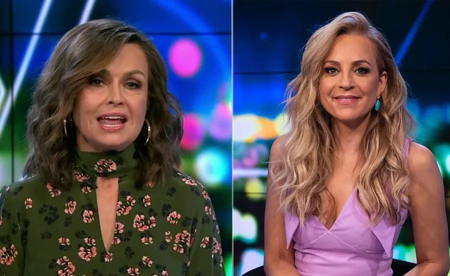 Two women in a studio setting, one in a floral dress, the other in a lavender top, with colorful blurred lights behind.