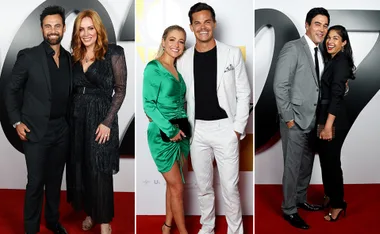 Group of three couples posing on a red carpet at a formal event, wearing elegant attire.