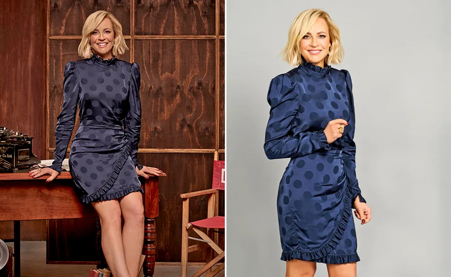 Blonde woman in a blue polka dot dress posing in a studio, smiling at the camera.