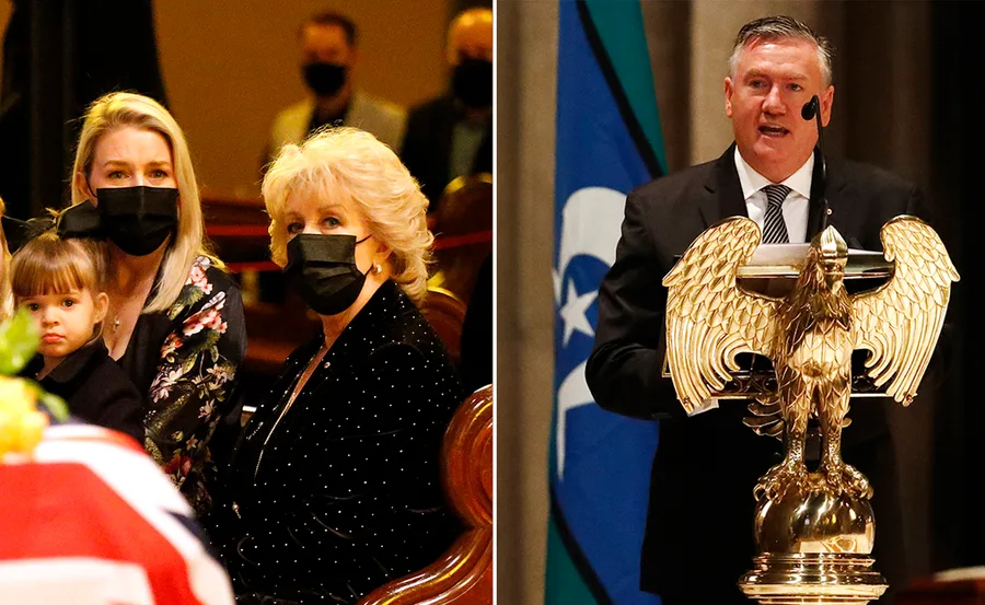 Two masked women and girl at funeral; man speaks at podium with eagle emblem.