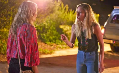 Two women arguing outside at night, one gesturing emphatically, in a scene from "Home and Away".