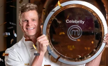 Nick Riewoldt celebrating with the Celebrity MasterChef trophy amidst falling confetti.