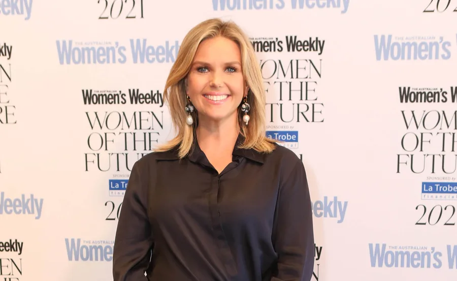 Woman smiling at Women's Weekly Women of the Future 2021 event backdrop.