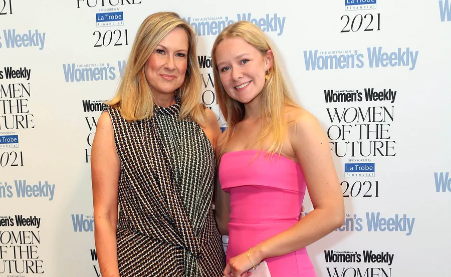 Two women smiling at the Australian Women’s Weekly Women of the Future event backdrop.