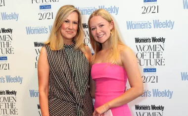 Two women smiling at the Australian Women’s Weekly Women of the Future event backdrop.