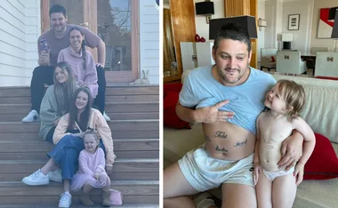 A family sitting on steps, and a man with tattoos showing his stomach to a smiling child indoors.