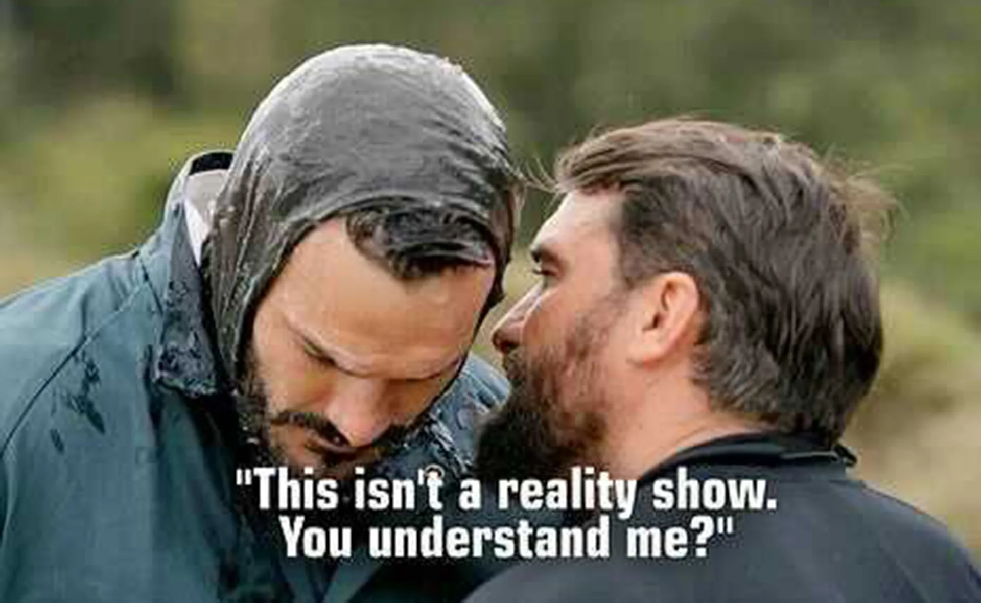 Two men are in a tense moment; one whispers, "This isn't a reality show. You understand me?"