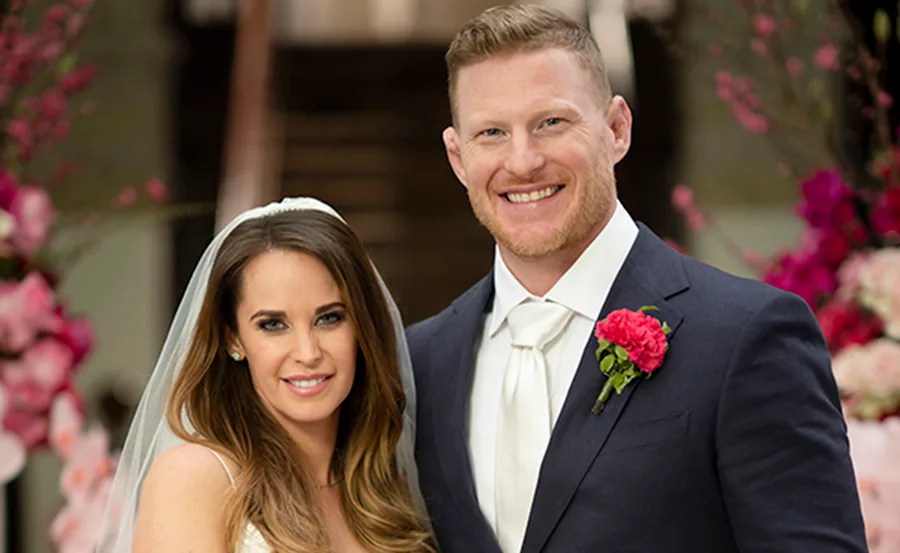 Bride and groom from "Married at First Sight" smiling, with floral background.