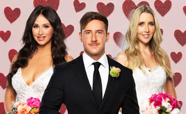 Three "MAFS" participants; two brides in white dresses with bouquets, and a groom in a black suit, smiling against a heart backdrop.