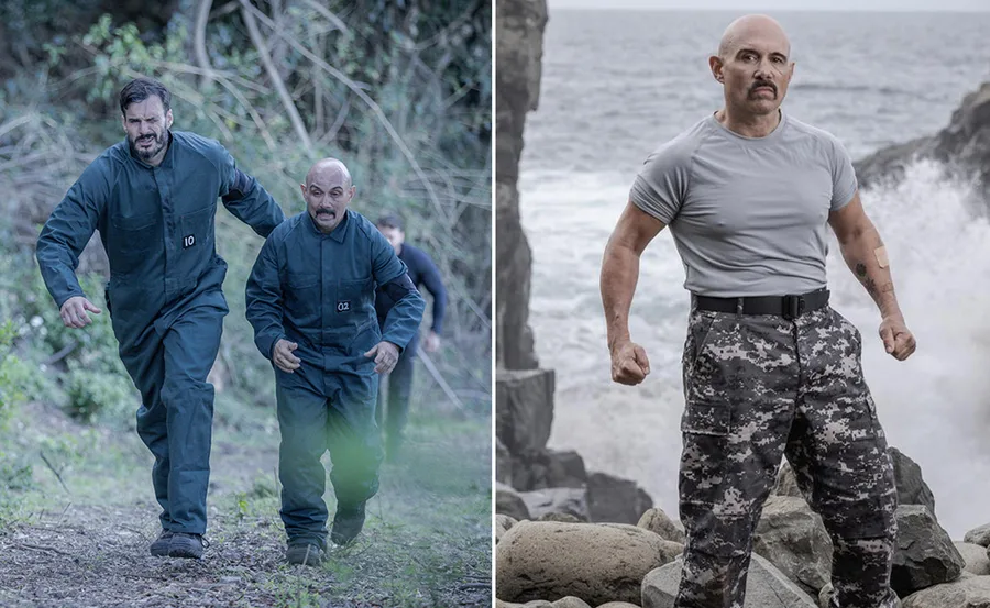 Two men in dark jumpsuits running, another man standing on rocks by the ocean in camouflage pants, arms tensed.