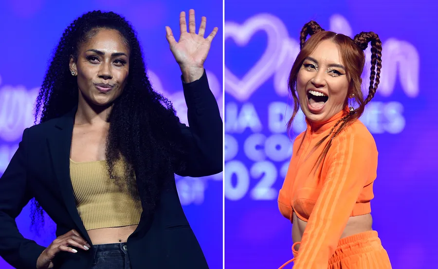 Two women on stage at Eurovision Australia Decides 2022; one waves, the other smiles widely.